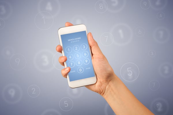 Female fingers touching smartphone with locked device requiring passcode