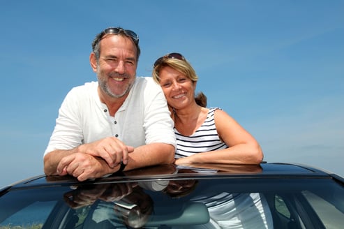 Senior couple in convertible car enjoying day trip