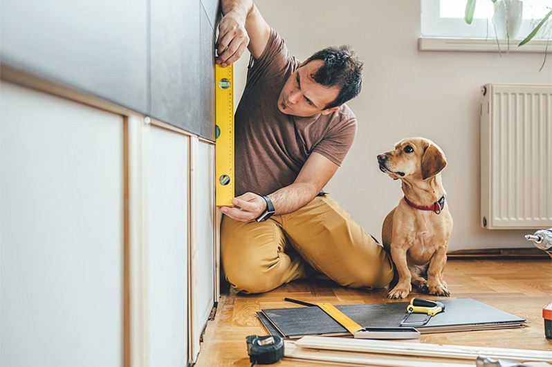 Man working on home with his dog