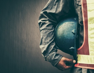 construction worker holding hard hat